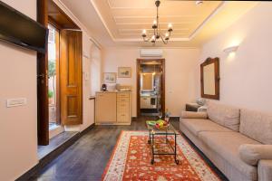 a living room with a couch and a table at Rodos Niohori Elite Suites Boutique Hotel in Rhodes Town