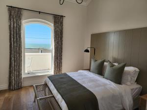 a bedroom with a large bed with a large window at Villa Moselle - St James in St. James