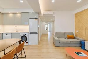 a kitchen and living room with a couch and a table at Setubal Horizon Apartment in Setúbal