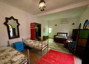 uma sala com um quarto com uma cama e um espelho em Funky Fes em Fez