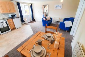 a living room with a dining table and a kitchen at Captivating 1-Bed Apartment in Stroud in Stroud