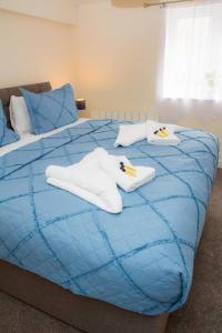 a blue bed with white towels on top of it at Captivating 1-Bed Apartment in Stroud in Stroud
