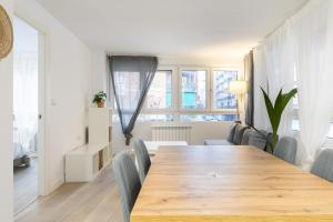 a dining room with a wooden table and chairs at Boutique Palencia Pensión in Palencia +25 photos