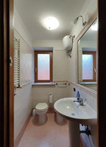 a bathroom with a toilet and a sink at Domus Laurenza in Acilia