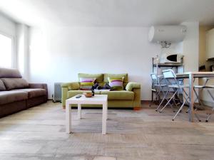 a living room with a couch and a table at Apartamentos Arttyfal con parking y WiFi by SURYNIEVE in Sierra Nevada