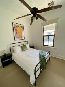 a bedroom with a bed with a ceiling fan at The Cottage at Seppeltsfield, Barossa Valley in Seppeltsfield +13 photos