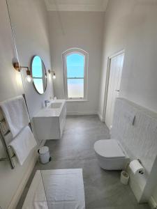 a white bathroom with a sink and a toilet at Villa Moselle - St James in St. James