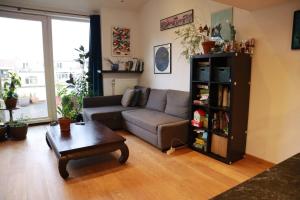 a living room with a couch and a coffee table at Appartement 2 chambres grande terrasse centre de Bruxelles in Brussels