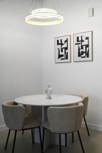 a dining room table and chairs with a white table at 2 Bedroom Apartment in Jeddah in Jeddah