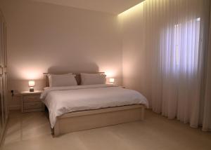 a bedroom with a bed with two lamps on it at 2 Bedroom Apartment in Jeddah in Jeddah