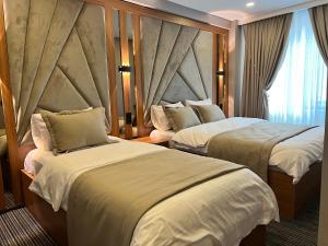 a hotel room with two beds and a window at istanbul vipinnhotels in Istanbul