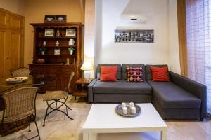 a living room with a couch and a table at WISH SUITE CALATRAVA DE SEVILLA in Seville