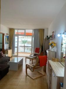 a living room with a couch and a table at Apartamento en Los Cristianos Edificio Guayero in Los Cristianos +12 photos