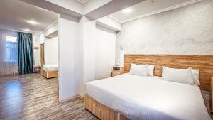 a bedroom with a large bed in a room at Hotel Bankir Khiva in Khiva