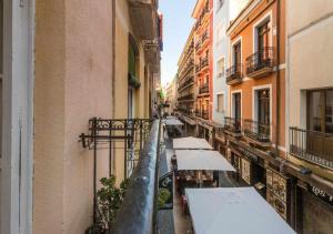 a city street with umbrellas and buildings in the rain at Old Town y Beach Holirent in Alicante