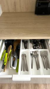 a drawer filled with lots of kitchen utensils at LouVi in Kehl am Rhein +15 photos