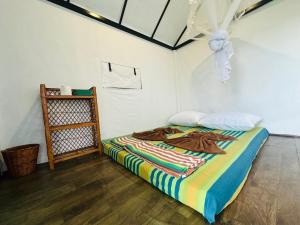 a bedroom with a bed with a colorful blanket at The Sky Tents in Kandy