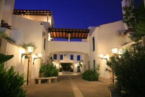 a courtyard of a house at night with lights at Hotel Slovenska Plaža in Budva