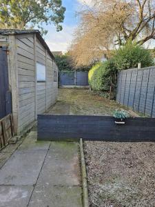a yard with a wooden fence and a building at Flaxton-Luxurious Home near NEC, BHX in Birmingham
