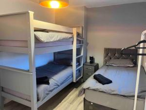 a bedroom with two bunk beds at Flaxton-Luxurious Home near NEC, BHX in Birmingham