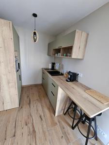 a kitchen with a wooden counter top in a room at The Pool house in La Farlède