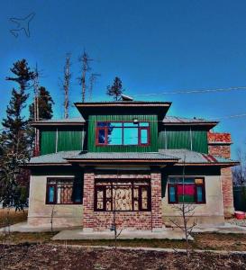 a large house with a green roof at Sheraz Guest House Ziran Gulmarg in Gulmarg