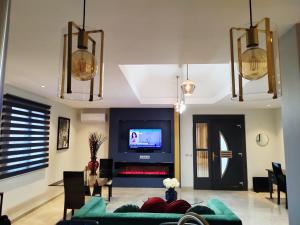 sala de estar con sofá y TV en Appartement Luxe dans Villa Borghese La Boisse, en La Boisse
