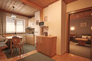 a kitchen and living room with a table and a couch at Appartements Charlotte in Westendorf