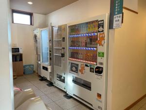 a vending machine with drinks in a room at Hotel Route-Inn Akita Tsuchizaki in Akita