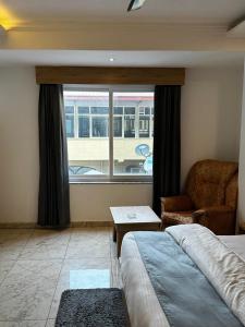 a bedroom with a bed and a window and a couch at Sonu Guesthouse & Hostel in Rishīkesh