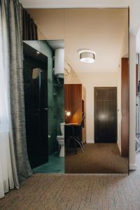 a bathroom with a toilet and a sink and a mirror at Garni Hotel Radović in Kragujevac