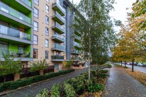 an apartment building with a walkway in front at The Park Royal Collection in London