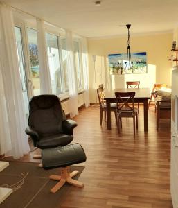 a living room with a chair and a table at Ferienwohnung Sonne und Meer in Ulstrupfeld