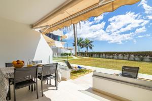 a dining room with a view of the ocean at HORIZON VACATION HOME - Firstline Las Burras in San Bartolomé de Tirajana