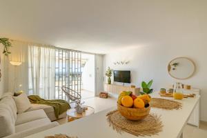 a living room with a bowl of fruit on a table at HORIZON VACATION HOME - Firstline Las Burras in San Bartolomé de Tirajana