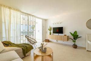 a living room with a couch and a tv at HORIZON VACATION HOME - Firstline Las Burras in San Bartolomé de Tirajana