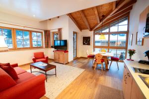a living room with a couch and a table at Chalet Isabella in Westendorf