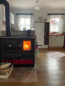 a kitchen with a stove with a fire in it at 11er Häusl in Flachau