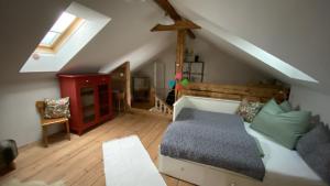 a attic room with a bed and a couch at 11er Häusl in Flachau