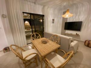 une salle à manger avec une table, des chaises et une télévision dans l'établissement Magnificent Apartment with Private Rooftop Terrace, à Tanger