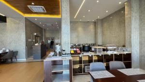 a restaurant with a table and chairs in a room at Royal Plaza Hotel in Duqm