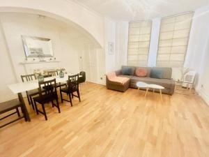 a living room with a couch and a table at 2 Bedroom flat in diplomatic enclave in Kensington in London