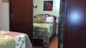 a small bedroom with a bed and a mirror at Two Bedroom Apartment at Golf Porto Marina in El Alamein