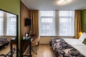 Postel nebo postele na pokoji v ubytování Jupiter Hotel