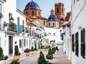 a street in positano with white buildings and blue domes at Apartamento en Altea con vistas al mar in Altea