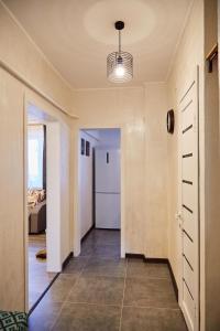 a hallway of a house with a door and a room at DeLuxe Ap Almaty Центр in Almaty