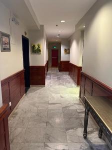 a hallway of a hair salon with a tile floor at مجمع رغدان السياحي in Al Baha