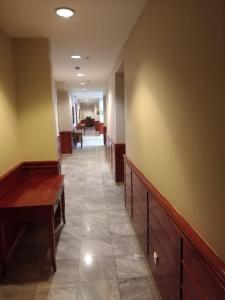 an empty hallway with desks and tables in a building at مجمع رغدان السياحي in Al Baha