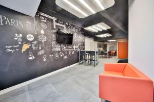 an office with a black wall with drawings on it at 02.Studio#Charenton#Fitness#Cinema in Charenton-le-Pont +9 photos