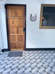 a door in a room with a checkered floor at Udon House in Udon Thani